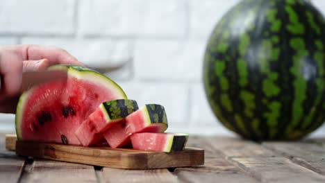 men hands cut watermelon on a cutting board.