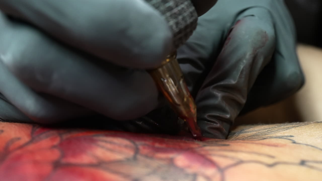 Professional tattoo artist shading his art on skin - Close up