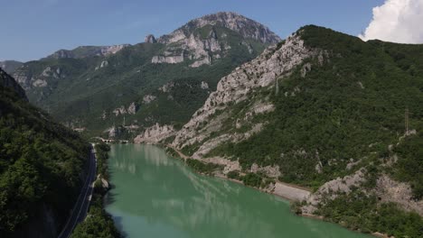 neretva river flowing through hills and mountains in mostar, bosnia