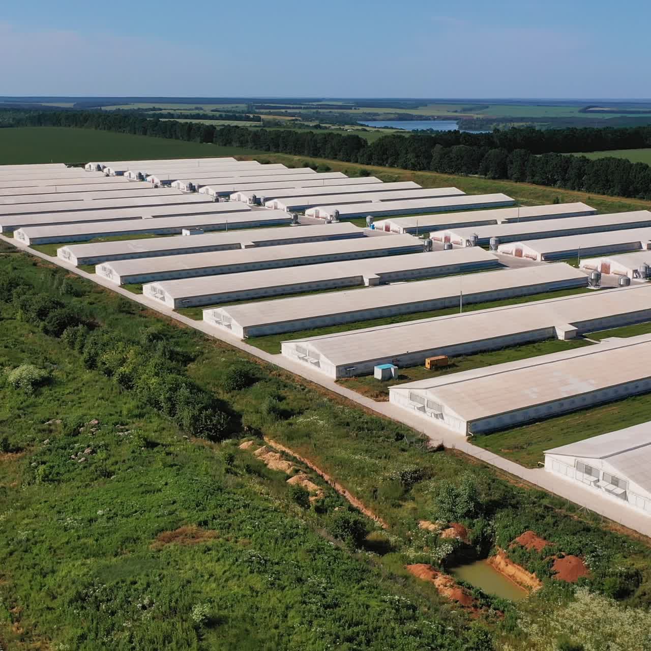 Aerial view of industrial big hangars. Outdoor exterior warehouse building