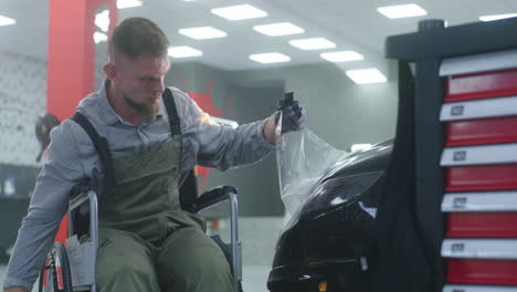 disabled auto detailer working on a car