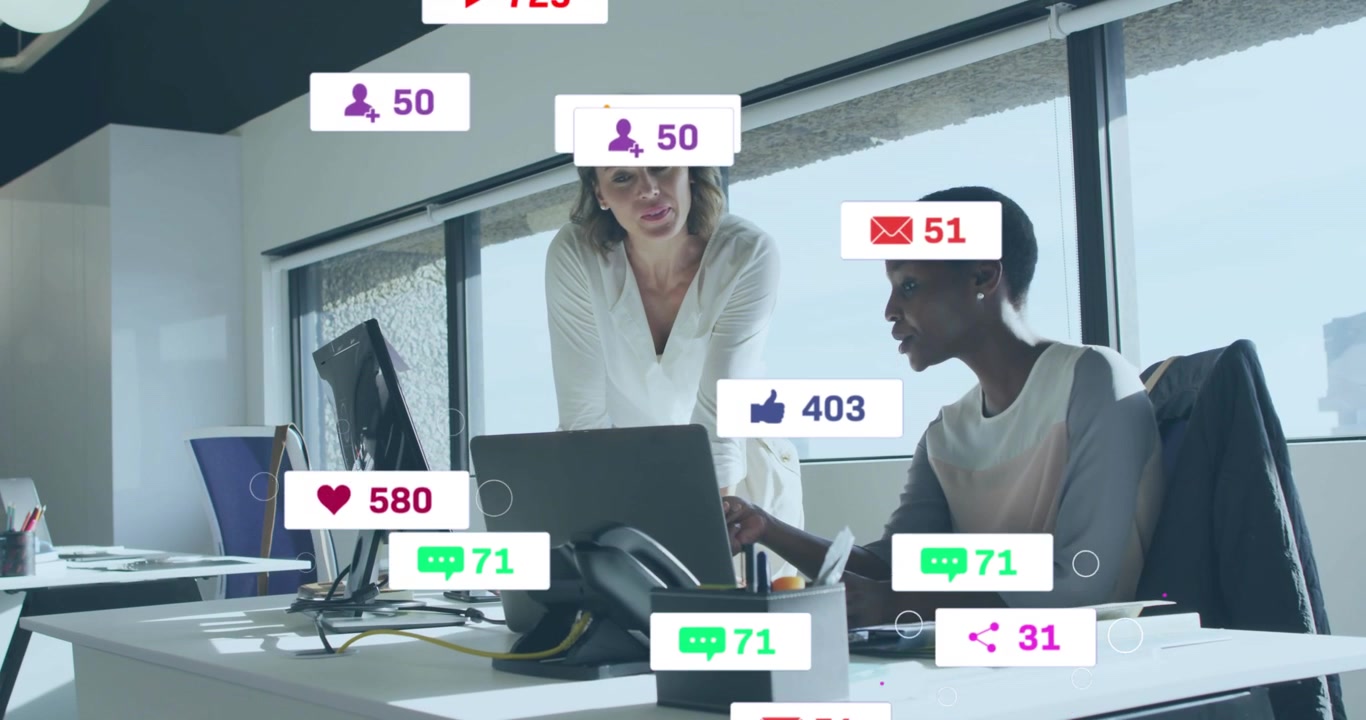 Standing woman pointing at laptop causing social media alerts peaking, fading, duo checking stats