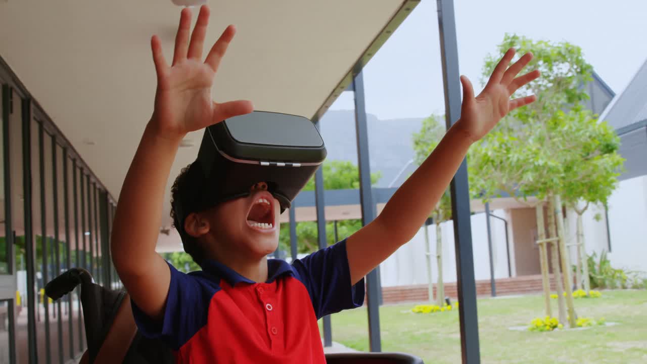 Front view of disabled African American schoolboy using virtual reality headset in school corridor 4