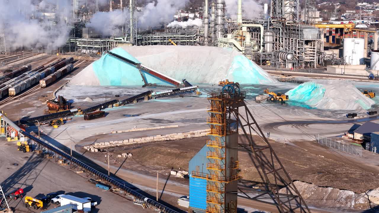 Wide view of Detroit salt mine facility with piles, conveyors, and loaders