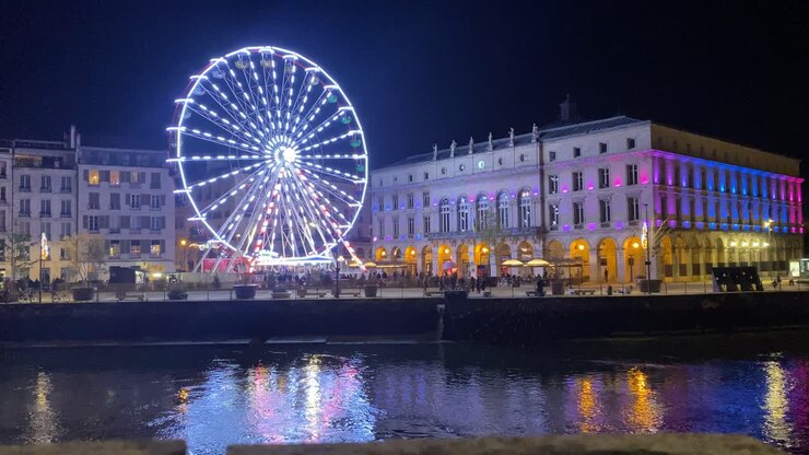 an impressive view of the Ferris wheel in the beautiful city of Bayona, illuminated by Christmas lights