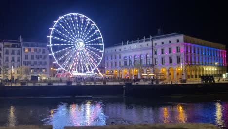 an impressive view of the ferris wheel in the beautiful city of bayona, illuminated by christmas lights