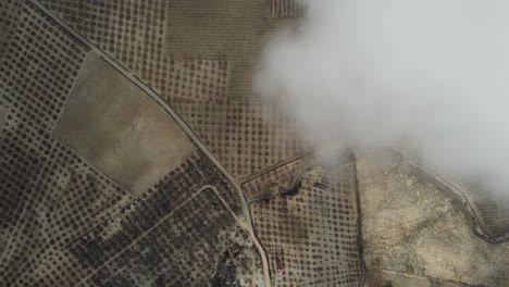 aerial view of farmland with clouds