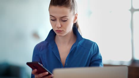 woman working on laptop and mobile phone