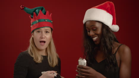 two women pull a christmas cracker