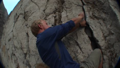 followingshot of a rock climber scaling a cliff face