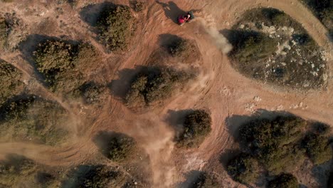 Aerial-view-looking-down-on-two-ATV-dune-buggies-race-and-then-leave-the-path-in-Cavo-Greko