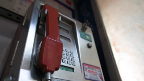 a public telephone booth, also called a payphone, with a red telephone receiver also is rapidly dying out and disappearing in the age of smartphones and the internet.