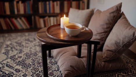cozy reading nook with tea and candle