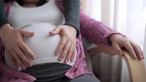 pregnant couple feels love and relax at home.