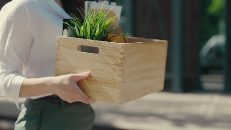 woman holding a box of belongings