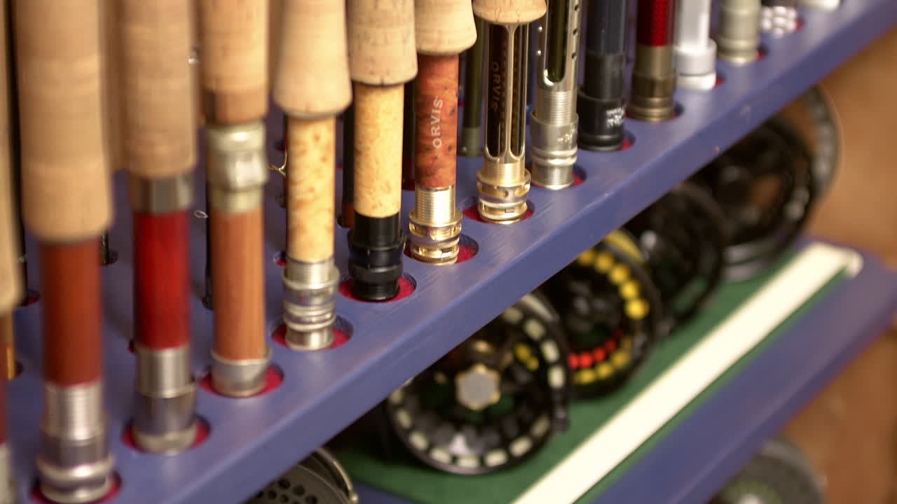 Many fly fishing reels and rods in a beautiful wooden box