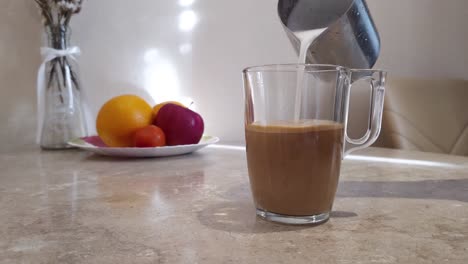 woman mixes milk with coffee