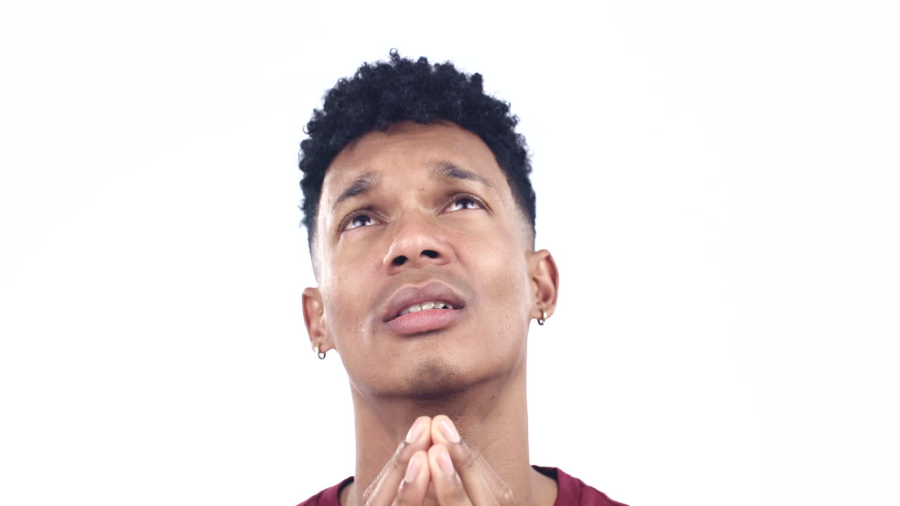 Crying, sad and face of man in prayer on white