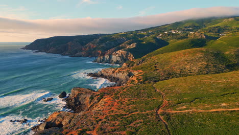 sunny ocean coastal landscape drone view. sea splashing shoreline washing stones