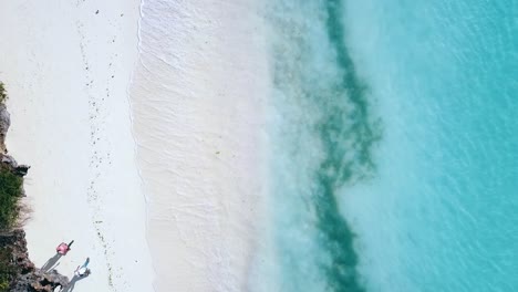 1 million $ aerial flight drone camera pointing down drone rocket shot strait up crystal clear turquoise water on a white sand beach zanzibar, africa 2019 cinematic filmed 1080, 60p at philipp marnitz