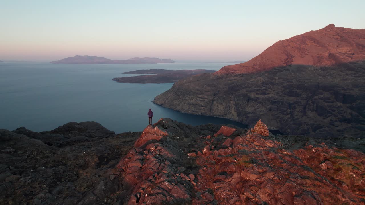 Male standing at Sgurr na Stri with a great view on Cuillin Mountains during sunset