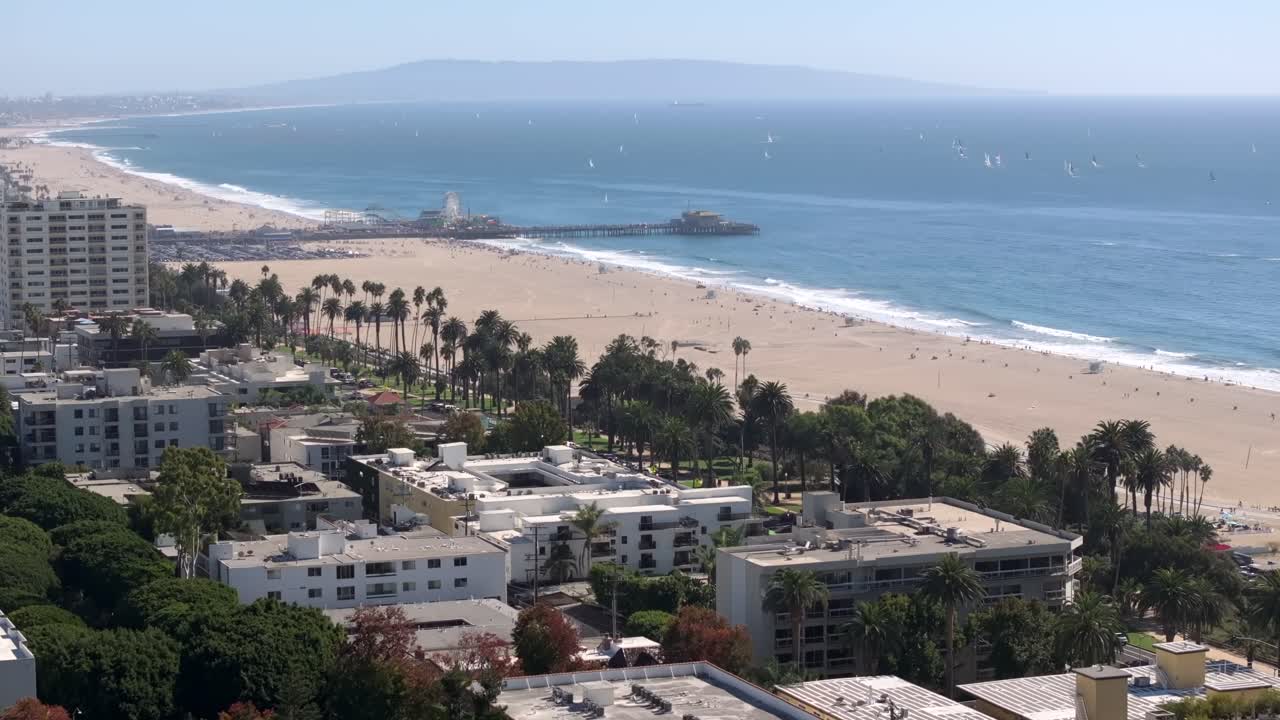 Santa Monica beach and ocean-front properties and the famous pier and amusement park - aerial flyover