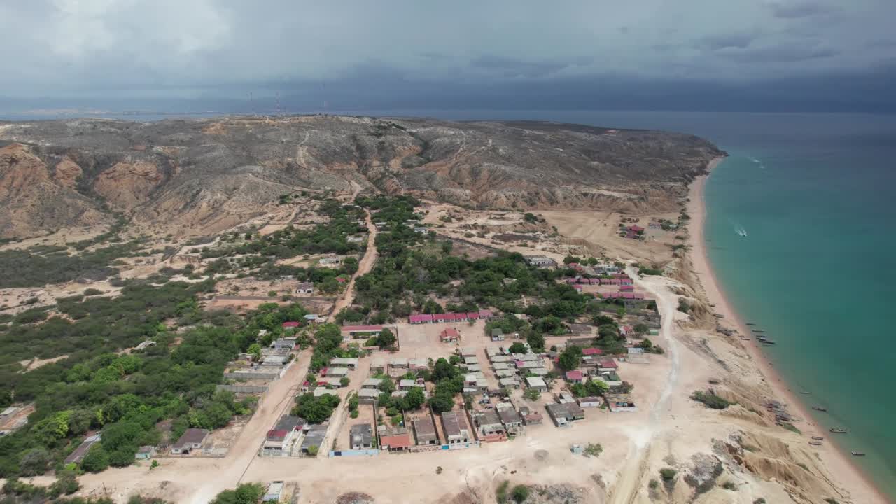 Aerial view of Araya village by the coast under overcast skies