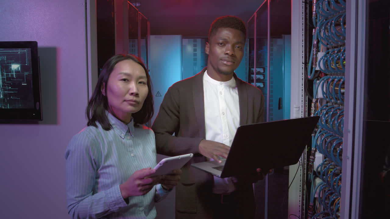 Network Engineers Posing in Data Center