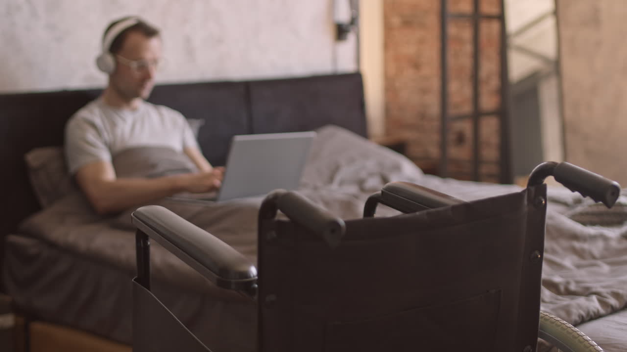 Blurred Man with Disability in Bed