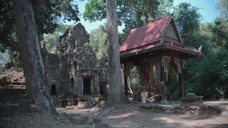 buddha and the gopura at prasat preah palilay in angkor, cambodia