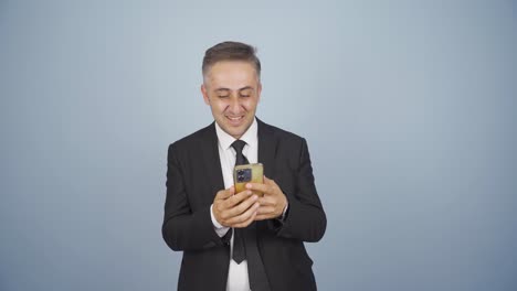 Businessman-texting-on-the-phone.-Happy-emoticon.