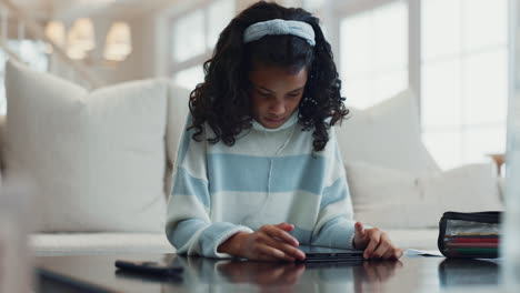 young girl studying on tablet