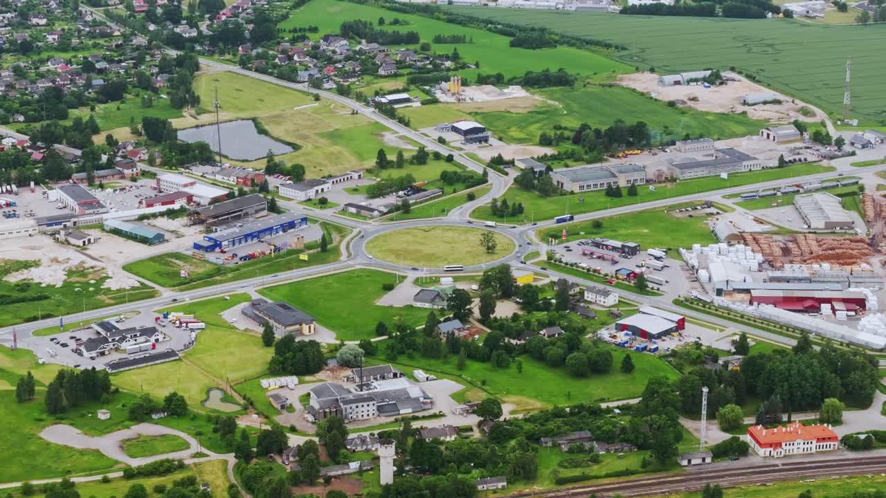 Drone view captures Saldus townscape and roads under calm cloudy daylight