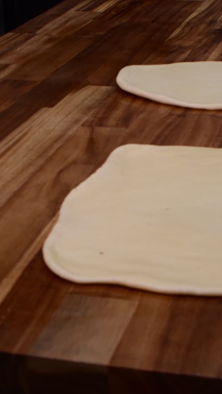 Raw baking dough rolled out on wooden counter close up