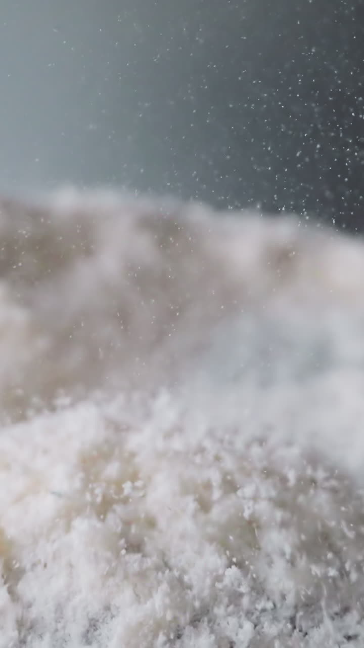 Powder-like narcotic substance lies on vibrating surface. Cocaine bounces up under influence of electromagnetic field. Movement of psychoactive elements macro