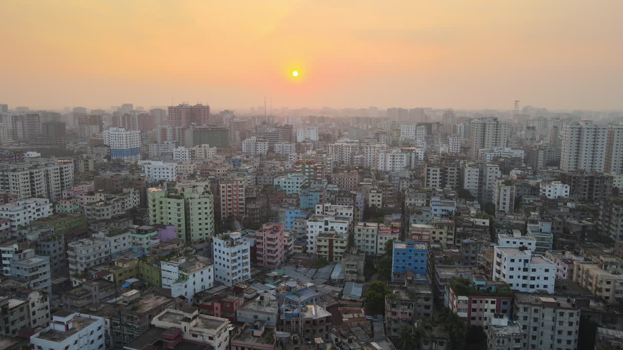 Drone flight over polluted city of Dhaka, sunset with smoggy horizon
