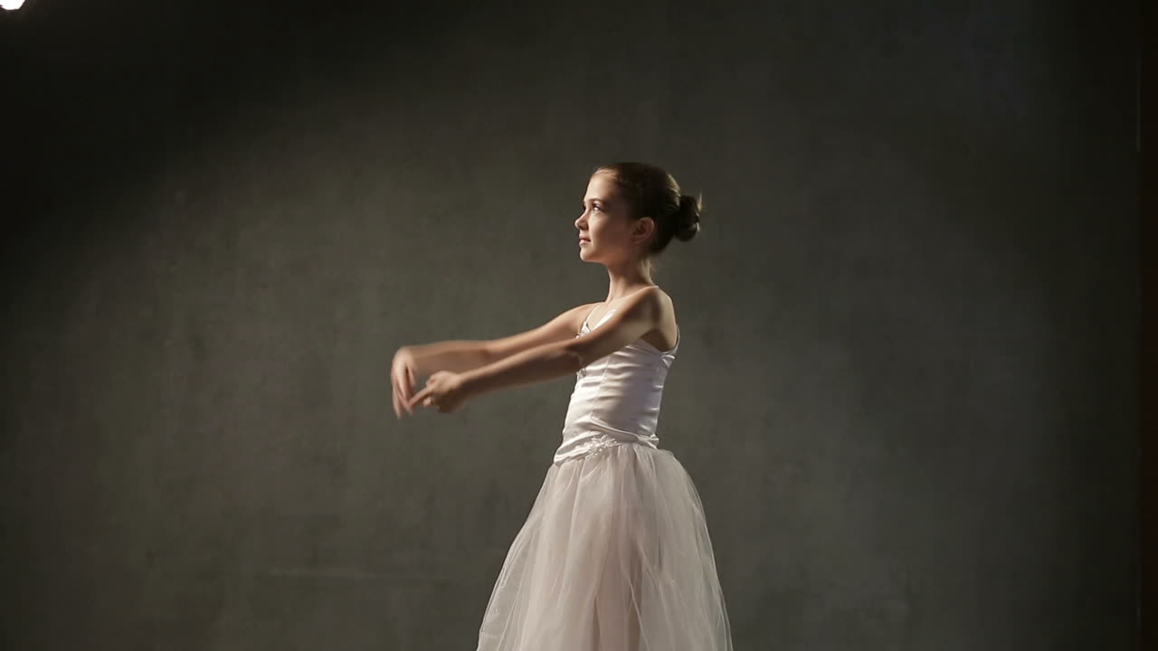 Ballerina In Tutu And Pointe. Little adorable young ballerina in tutu and pointe in the black studio