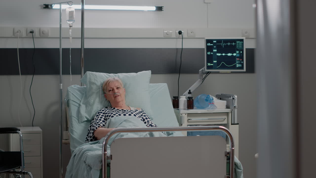 Doctor and nurse visiting patient with illness in hospital ward