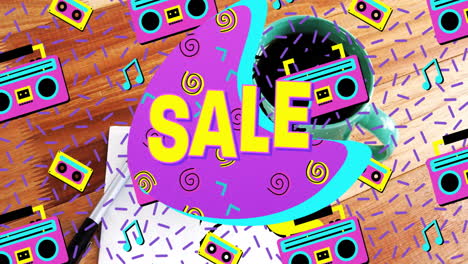 promotional sale graphic glowing over desk, featuring neon retro shapes and cassette icons