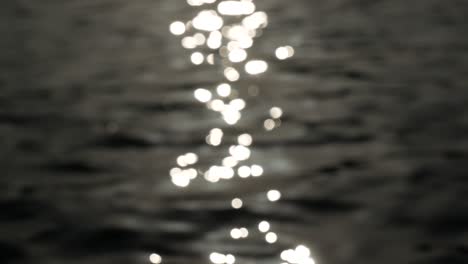 blurred reflection on rippled water, wavy liquid surface reflecting light, abstract nature background