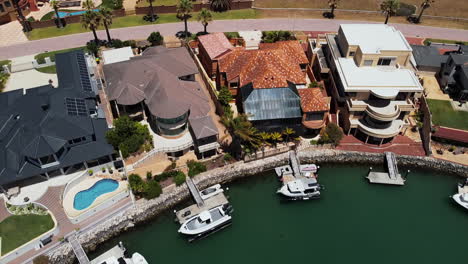 aerial view of luxury townhouses by the sea, with private dock for boats