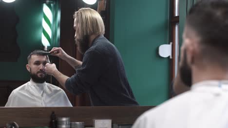 professional barber giving a haircut to a male client in a barbershop
