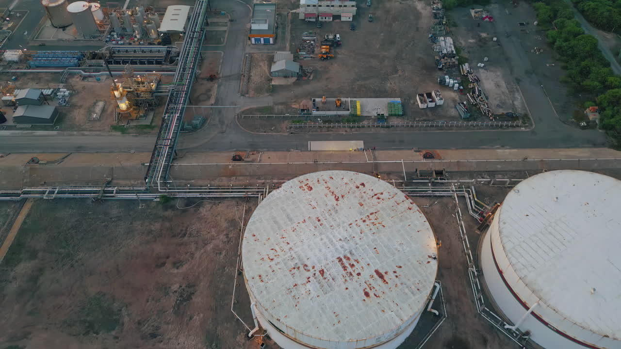 Petrochemical plant tanks top view. Drone flying over industrial infrastructure