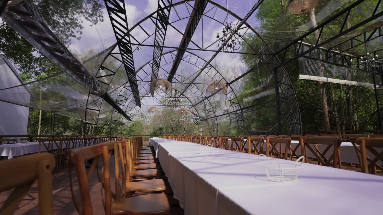 Elegant transparent glass gazebo set for wedding reception in jungle environment, luxury event venue, Parana, Iguazu, Argentina