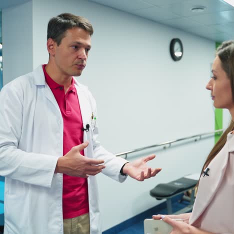 young doctor talking to a woman. professional male doctor consulting to a beautiful woman in medical center.