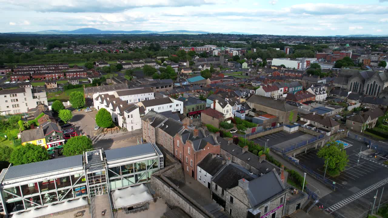 Backward drone over Limerick city and King John's Castle on clear day