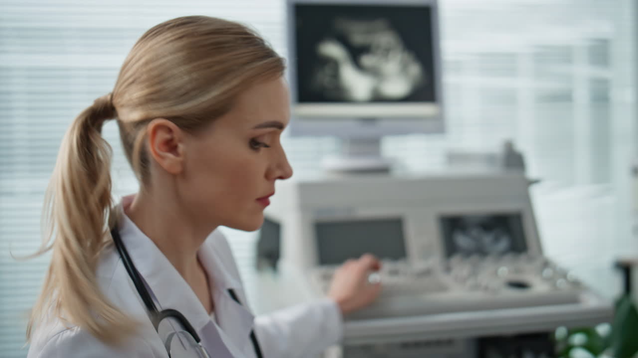 Closeup doctor looking ultrasound image on monitor. Healthcare worker checking