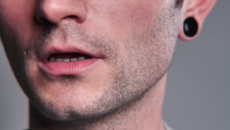 young man with black tunnels in the ears