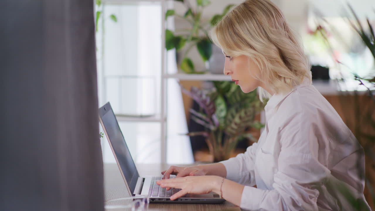 Woman Working Remotely from Home on Laptop