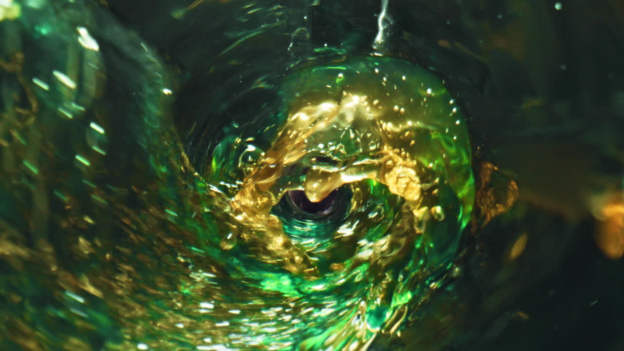 Pale ale bubbling goblet closeup. Alcohol hoppy drink splashing pouring glass